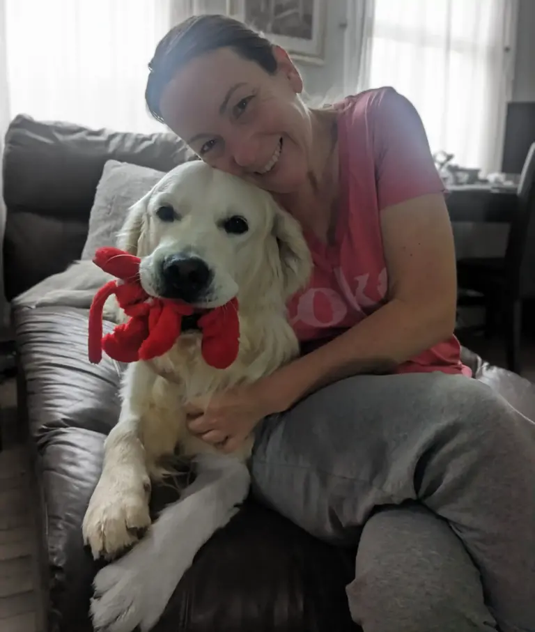 Lindsay (Fairy Dogmother) hugging a golden retriever